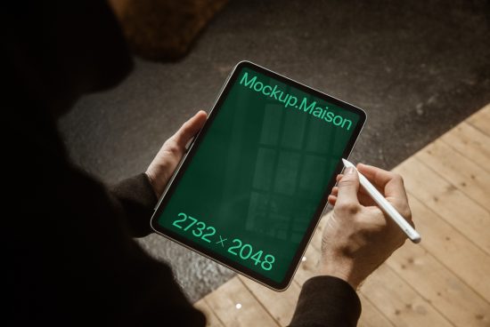 Person holding a tablet with a screen mockup, showcasing design space 2732x2048 px, perfect for graphics, templates, and presentations.