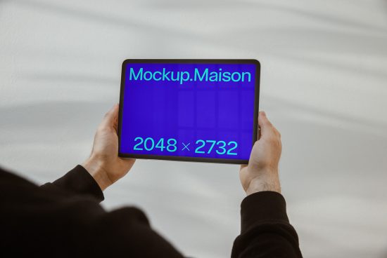 Person holding tablet displaying blue screen Mockup.Maison with dimensions, digital asset for designers, ideal for presentations, templates.