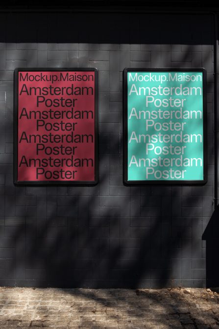 Urban poster mockups against a dark brick wall with contrasting shadow play, visualizing design presentations in real-world settings for designers.