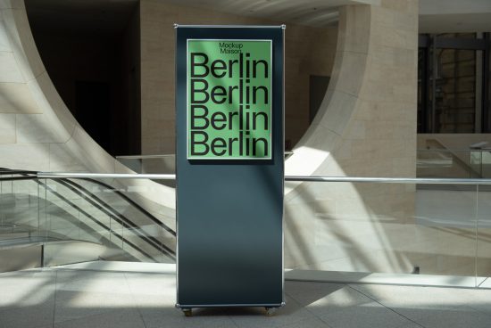 Roll-up banner mockup in a modern lobby displaying bold green Berlin font design, ideal for presentations and branding.
