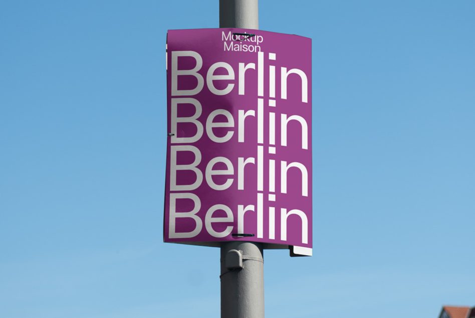 Pink pole-mounted banner with Berlin repeated in silver text in daylight