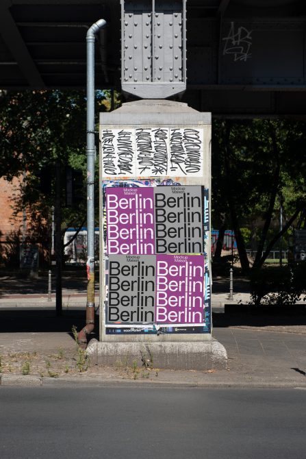 Urban poster mockup on a bright day featuring repeated 'Berlin' text in various fonts ideal for designers looking to present street level advertising.