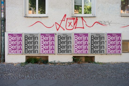 Urban poster mockup display with multiple identical posters reading Berlin on a city building wall, showcasing street-style advertising, suitable for graphic design marketplace.