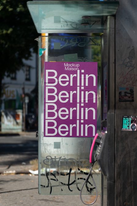 Urban poster mockup on a public phone booth with bold typography design reading Berlin, ideal for presentations and city branding graphics.