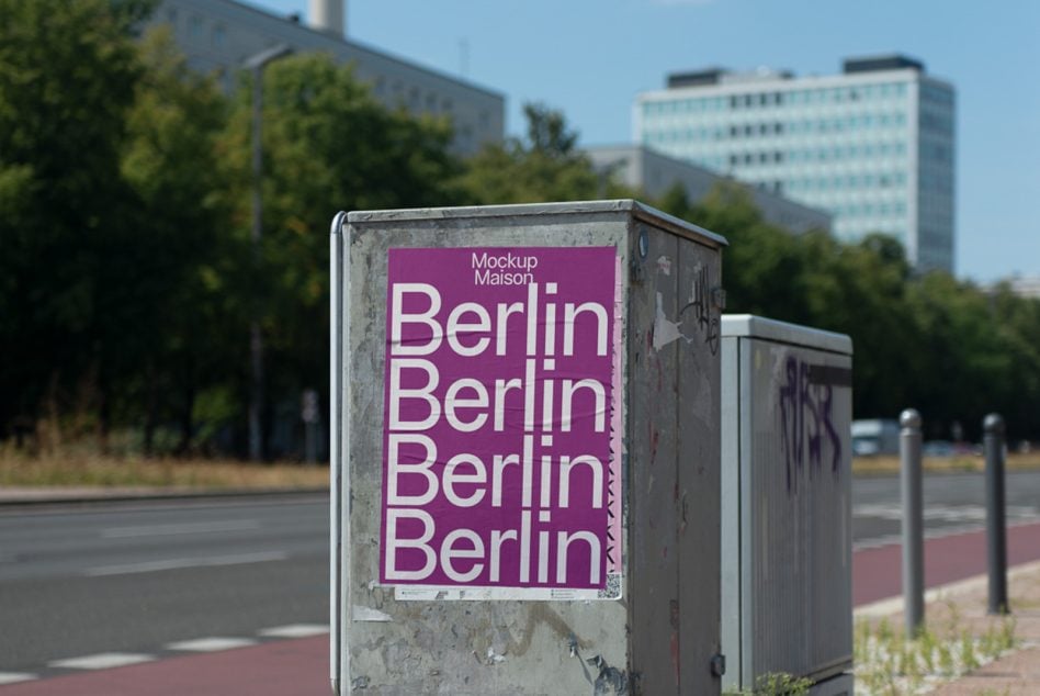 Street-level utility box featuring purple poster with white Berlin text repeat