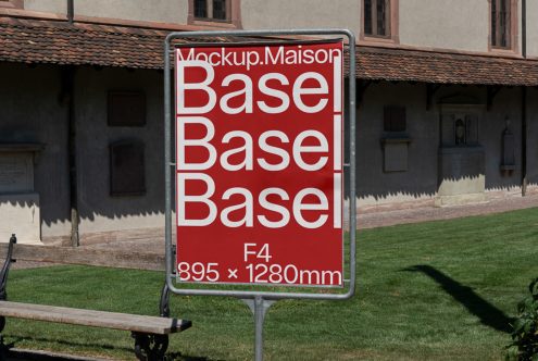 Outdoor billboard mockup showcasing red poster with bold typography in front of historic building, designers can visualize real-world applications.