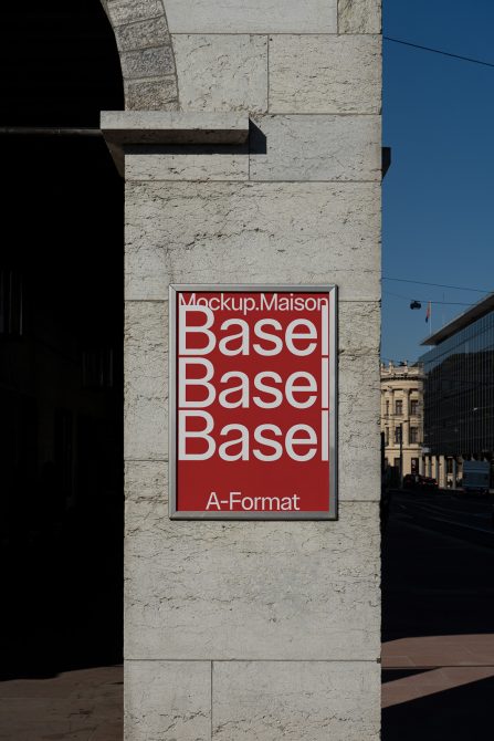 Red A-Format poster mockup mounted on cream stone wall in Basel