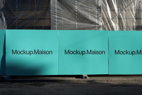 Outdoor advertising mockup on construction barrier with clear sky, ideal for presentations and branding. Graphics display, mockup design, urban setting.