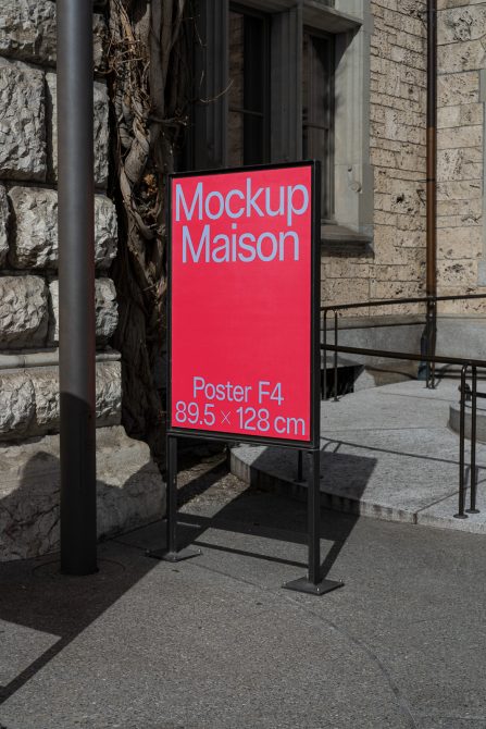 Red poster mockup on a sidewalk with urban background, depicting a clear F4 size display for designers to showcase their work.