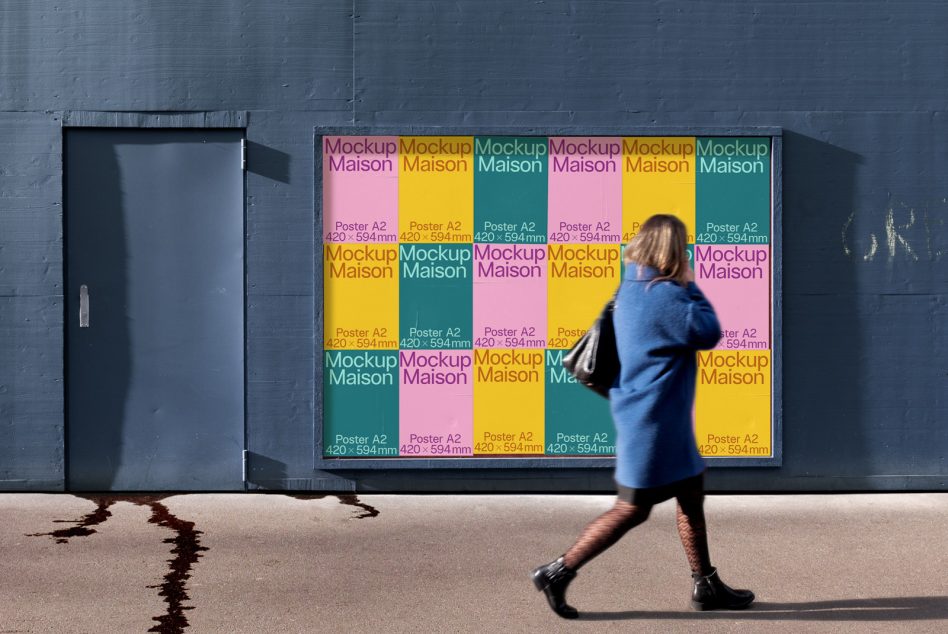 Person jogging past colorful grid poster mockup on gray wall in daylight