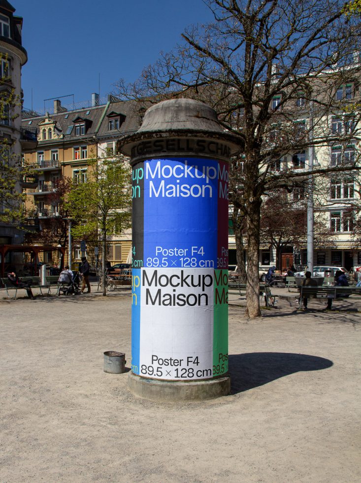 Urban poster column mockup for outdoor advertising in a city environment with clear blue sky and buildings in the background.