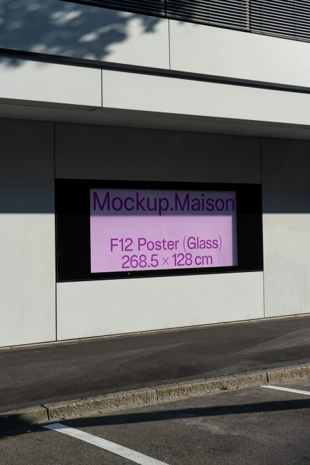 Outdoor poster mockup displayed on a modern building facade for graphic design presentations and portfolios.