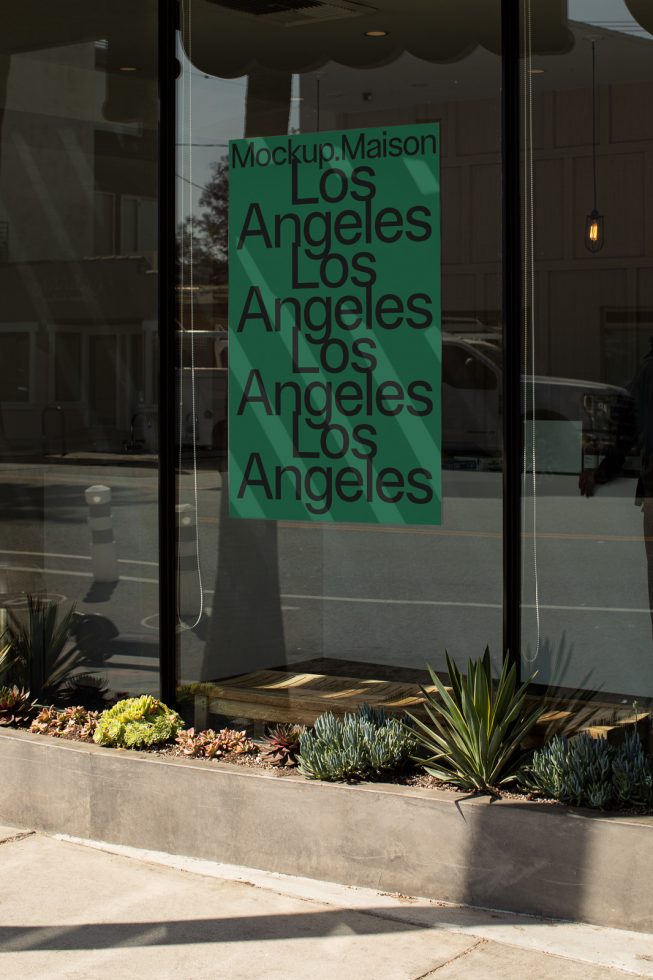 Storefront glass window mockup with text overlay in urban setting ideal for display font design showcase for graphics and typography designers.