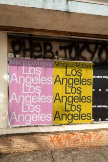 Weathered building entrance with split pink plus yellow poster mockup displaying Los Angeles typography