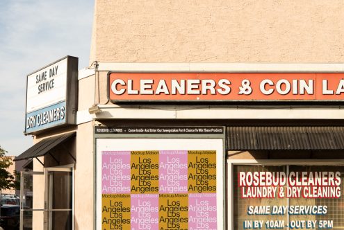 Urban storefront signage with clear typography, suitable for mockup graphics and templates related to business branding and marketing.