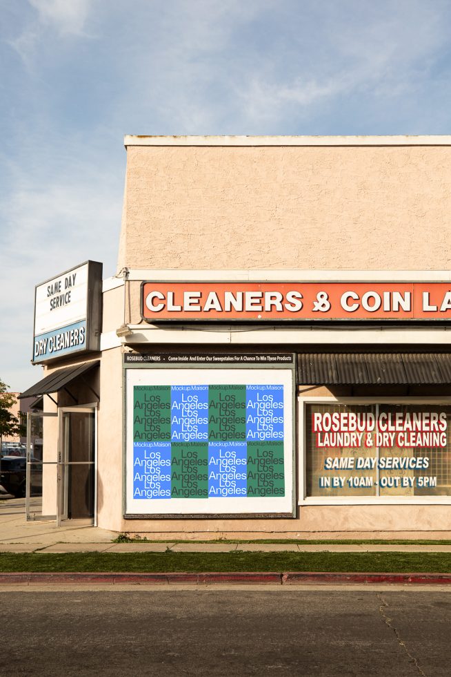 Urban storefront with signage mockup under clear skies, perfect for showcasing design in situ for graphics and templates.