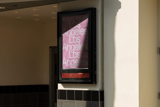 Outdoor poster mockup display in sunlight for showcasing advertising design, placed on urban building wall, features repetitive text 'Los Angeles'.