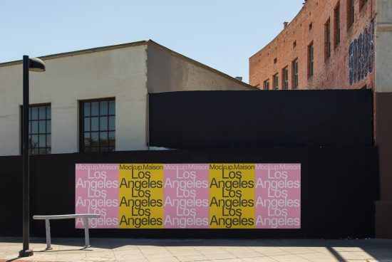 Urban billboard mockup with repeated 'Los Angeles' text in stencil font on sunlit street wall, ideal for graffiti-style graphics display.