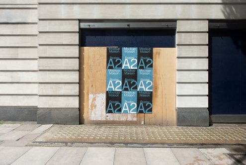 Urban A2 poster mockup on a wooden board outside a closed store with Mockup Maison branding, for designers and advertising.