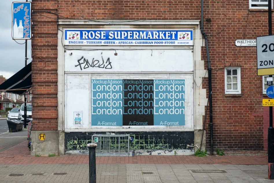 Boarded up storefront with three blue poster mockups showing repeating London text