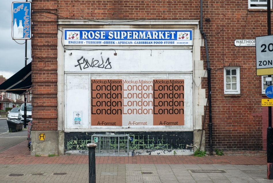 Abandoned storefront with three-poster horizontal layout showing London wordmark on terracotta