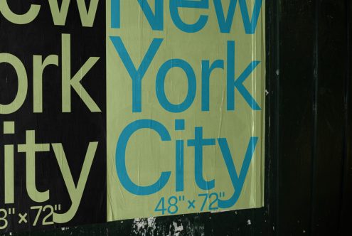 Torn poster on wall with "New York City" text, urban distressed graphic design element for mockups and templates.