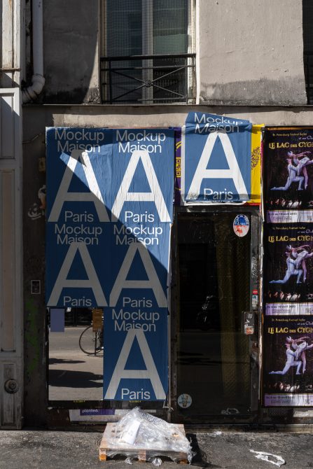 Urban storefront covered in blue mockup advertising banners with white typography for design presentation.