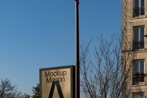 Outdoor billboard mockup displayed in an urban setting, clear blue sky background, suitable for designers to showcase advertising work.