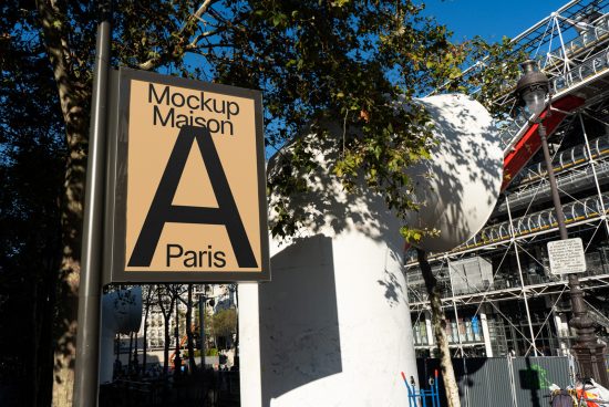 Outdoor street sign mockup with bold A lettering, labeled Mockup Maison Paris, against an urban backdrop with trees and construction.
