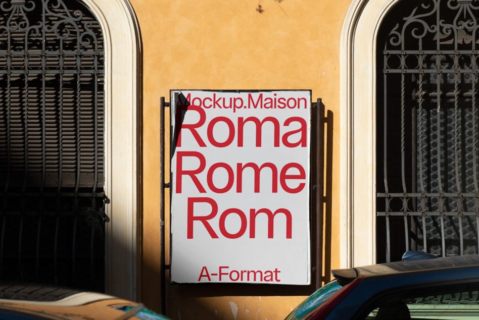 Red typography on white poster flanked by ornate iron grilles