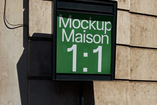 Outdoor signage mockup display on a sunlit wall with a green background and white text reading "Mockup Maison 1:1", ideal for designers' presentations.