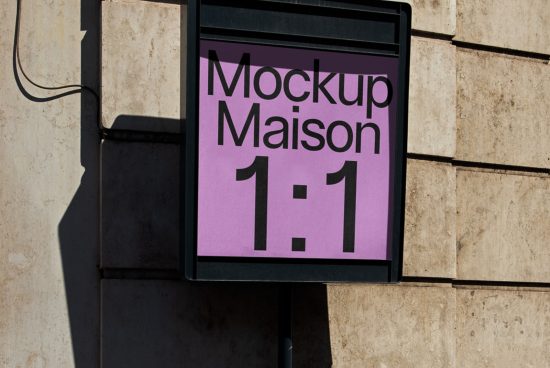 Outdoor signage mockup on a stone wall displaying a purple poster with the text Mockup Maison 1:1, ideal for presenting brand designs.