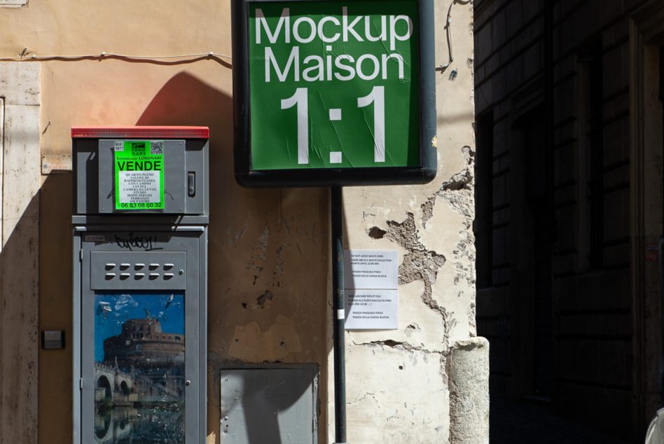 White text on green rounded square mounted on crumbling wall in historic area