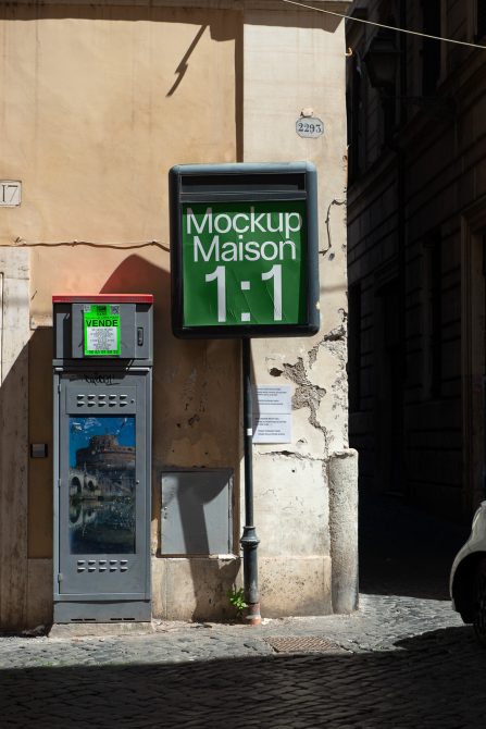 Green square sign on aged facade with payment machine beside it on old street