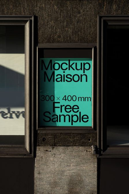 Street poster mockup in a metallic frame on a textured wall displaying text Mockup Maison, 300x400mm Free Sample. Perfect for designers presentations.