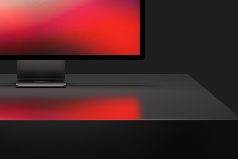 Sleek computer monitor mockup with vivid display on a dark studio background, ideal for presenting digital design work to clients.