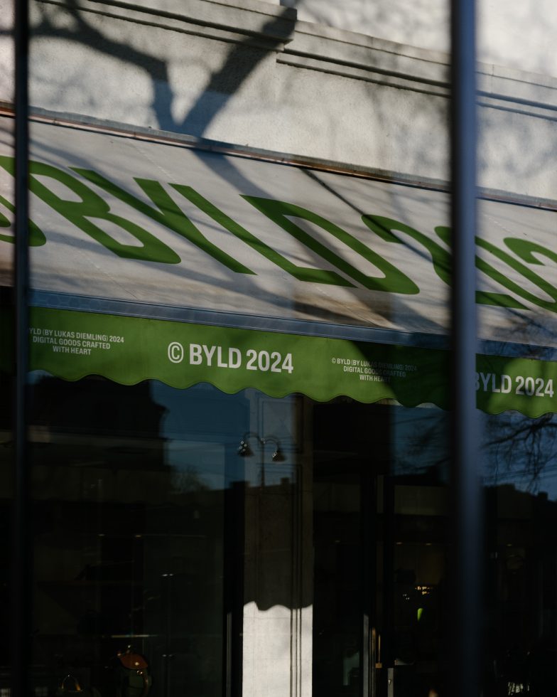 Green and white storefront signage mockup with reflections and shadows, suitable for designers to showcase branding projects.