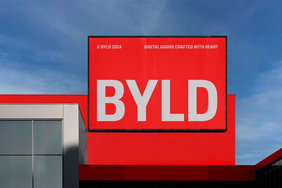 Red billboard with bold white lettering BYLD, against a blue sky for Mockups category, digital design assets, branding mockup.