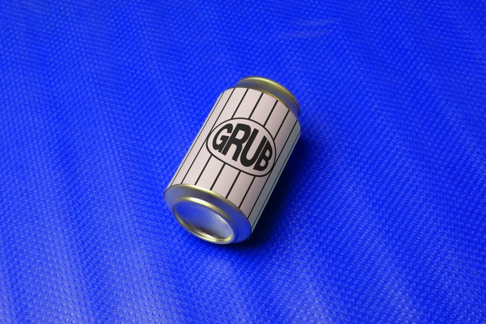 Product packaging mockup of a soda can with minimalist design on blue bubble wrap background, ideal for brand presentation.