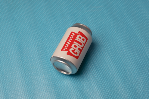 Realistic soda can mockup on blue textured background, ideal for branding and packaging design presentations.