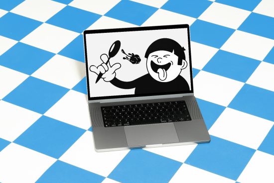 Laptop on blue checkered background with cartoon character graphic on screen, playful design, digital asset for graphic designers.