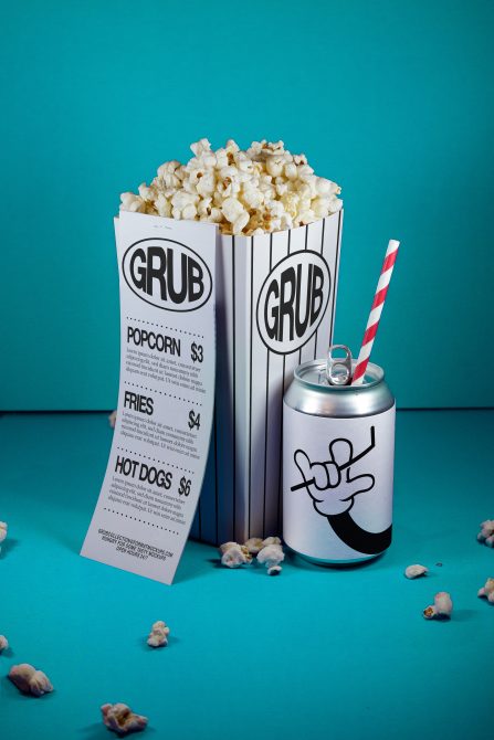 Creative mockup of popcorn box, soda can with straw, and menu for designers featuring playful graphics on a teal background.