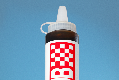 Realistic glue bottle mockup with label design against a blue background, ideal for branding and packaging presentations.