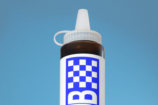 Realistic dropper bottle mockup with blue and white label design against a sky-blue background, for packaging and branding graphics.