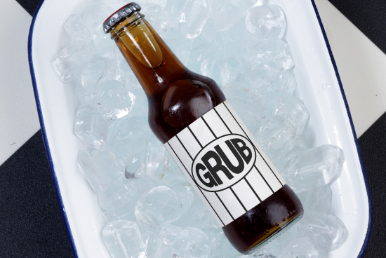 Beer bottle mockup on ice in enamel tray, realistic packaging design, beverage branding presentation, graphic design elements.