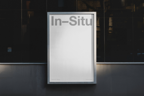 Urban billboard mockup against a dark building facade for presenting advertising designs with text placeholder, ideal for designers.