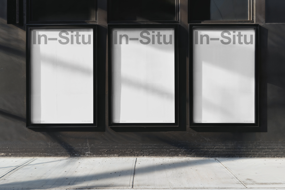 Three vertical blank poster mockups in black frames on a street wall, ideal for outdoor advertising design presentations.