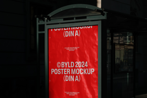 Outdoor poster mockup on bus stop shelter with red background and white text, designer resource, visible in natural environment for advertising.