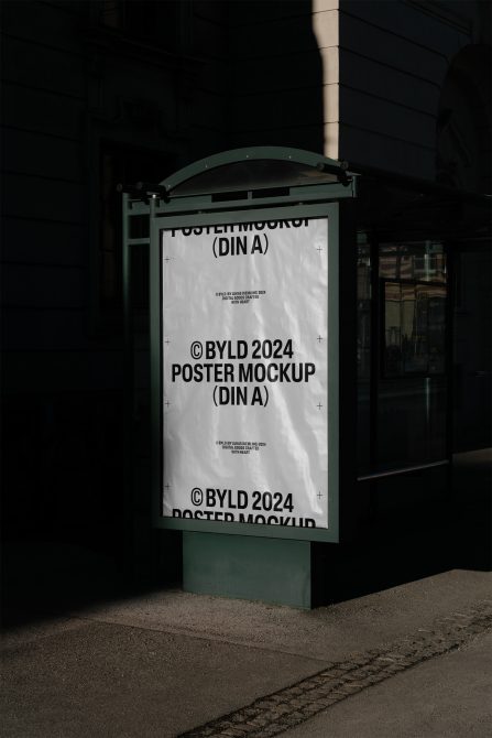 Street poster mockup showing DIN A format on green shelter at night