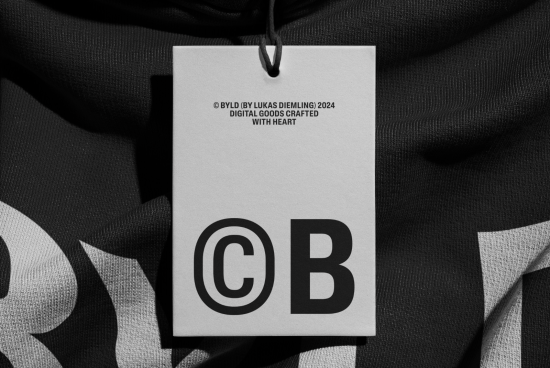 Alt: Black and white clothing tag mockup with bold lettering, ideal for apparel design presentation and graphic display from 2024 collections.